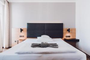 Postel nebo postele na pokoji v ubytování Ambienthotel Tassilo