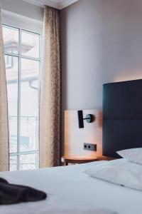 Postel nebo postele na pokoji v ubytování Ambienthotel Tassilo