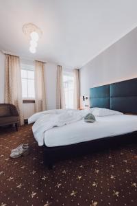 Postel nebo postele na pokoji v ubytování Ambienthotel Tassilo