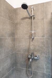 a shower with a shower head in a bathroom at FarawayHomes Studio Fohnsdorf #13 in Fohnsdorf +16 photos