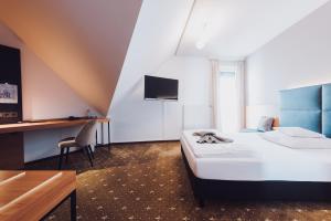 Postel nebo postele na pokoji v ubytování Ambienthotel Tassilo