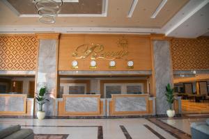 a lobby with a hotel sign on the wall at Rewaya Majestic Resort in Hurghada +37 photos