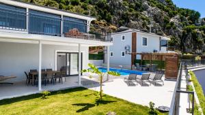 a villa with a view of a house with a pool at Selimiye Mia Villa's in Selimiye