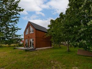 a small house in a field with trees at Chatka Czarodzieja in Parlin