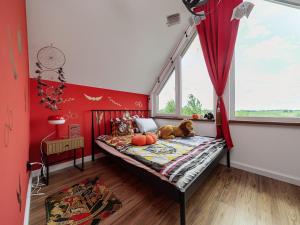 a bedroom with red walls and a bed with a stuffed animal on it at Chatka Czarodzieja in Parlin