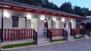 a small house with chairs on the porch at Bujtina4A Rrenc in Renc +23 photos