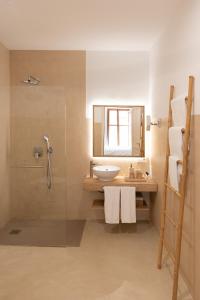 a bathroom with a sink and a shower at Petit Biniaraix in Sóller