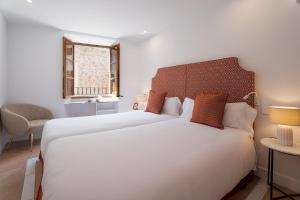 a bedroom with two beds and a window at Petit Biniaraix in Sóller