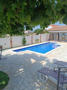 a swimming pool in a backyard with a table and chairs at Villa Granda in Visočane +10 photos