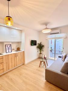 a living room with a couch and a kitchen at Apartamentos Ana Marbella centro in Marbella