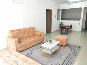 a living room with a couch and a table at GRANDE MAISON 3 NEAR AFAMOSA WaterPark in Kampong Pulau Sebang