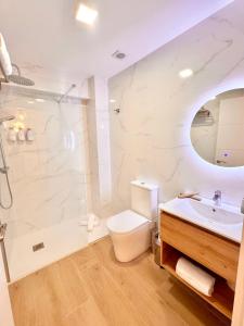 a bathroom with a toilet and a sink and a shower at Apartamentos Ana Marbella centro in Marbella +68 photos