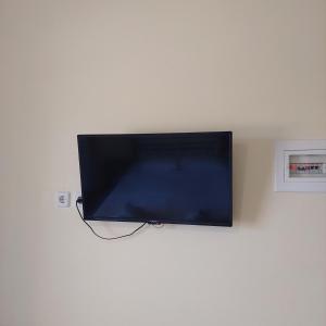 a flat screen tv hanging on a wall at Casa Gustosa Μονεμβασιά in Monemvasia