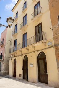 a building with a balcony on top of it at Aria di Mare Apartments in Trapani