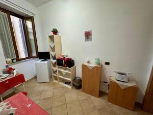a room with a kitchen with a refrigerator and a table at Al Papavero Rosso in Castellammare di Stabia