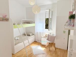 a room with a bunk bed and a chair at Luna Serene Garden Home - Jacuzzi & Gym in Zadar
