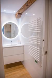 a white bathroom with a sink and a mirror at TxOKO ETXEA in Bermeo