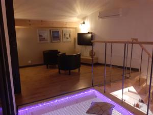 a living room with a swimming pool and a tv at Charmante maison atypique in Régusse