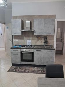 a kitchen with a stove and a sink at 40 Parallelo in Castel Volturno