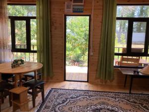 a room with a table and a door with windows at Мачу Пикчу in Cholpon-Ata