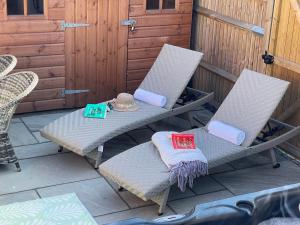 two chairs and a table on a patio at Luxury Georgian home, hot tub, sea view, private garden, sleeps 6 in Bognor Regis +45 photos