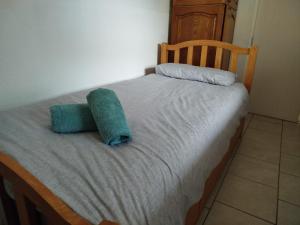 a small bed with two pillows on it at Smallest bird's HAVEN in Bloxwich