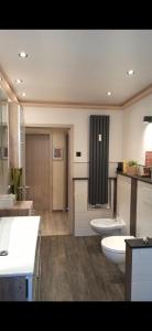 a large bathroom with two sinks and two toilets at Zum Fuchskopp in Daun +7 photos