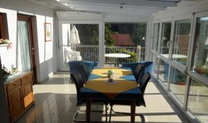 a dining room with a table and chairs on a porch at Ferienwohnung in Gamlitz