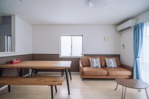 a living room with a couch and a table at Comfort Miyabi -4号棟 in Yomitan