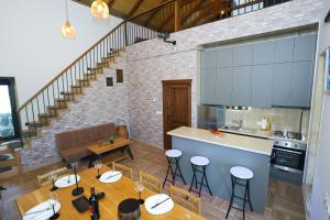 a kitchen and living room with a table and chairs at River Home Villa in Kʼaghsi