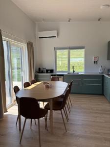 a kitchen and dining room with a wooden table and chairs at Sigurstapi, Borgarfjörður Eystri in Borgarfjörður Eystri