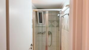 a bathroom with a shower with a glass door at Wake in the Lake in Agios Nikolaos +54 photos