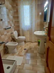 a bathroom with a toilet and a sink at Casa Emilia in Marano Principato +26 photos