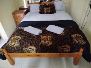 a bed with two towels on top of it at medium birds haven in Bloxwich