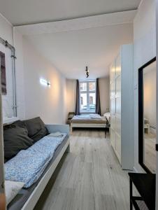 a small bedroom with a bed and a window at Fabryczna Station Rooms and Apartments in Łódź