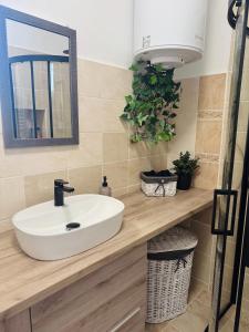 a bathroom with a white sink and a mirror at Apartman Classy Pécs in Pécs +16 photos