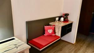 a small booth with a red seat in a room at Hotel Am Rupertuspark in Bad Reichenhall