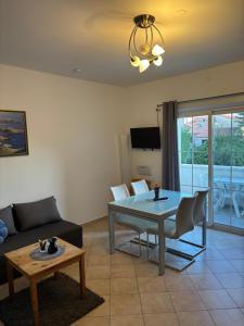 a living room with a couch and a table at Villa Maslina in Zadar