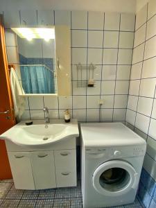 a bathroom with a washing machine and a sink at Aleka home in Stavros +19 photos