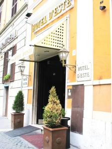 a hotel building with two potted trees in front of it at Hotel d'Este in Rome