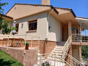 a house with a staircase in front of it at Casa Los Naranxales Gijon in Gijón