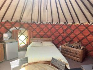 a bedroom with a bed in a yurt at Séjours nature et bien être en YOURTE in La Pesse
