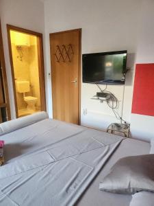 a bedroom with a bed and a flat screen tv at room&4you in Supetar
