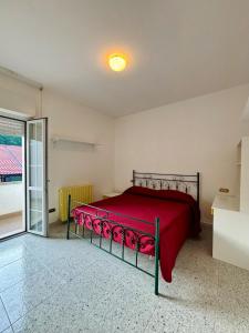 a bedroom with a bed with a red bedspread at Villa Madonnina in riva al fiume Tirino in Bussi sul Tirino