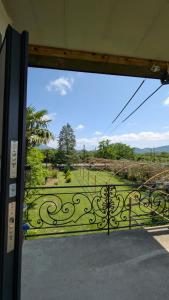 an open door with a view of a garden at Guesthouse Martvili Canyon 'Kolkhi' 