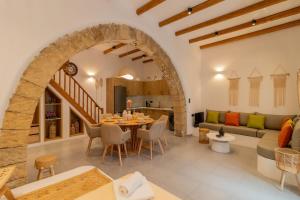 a dining room and living room with a table and chairs at Antonis Traditional House in Afantou