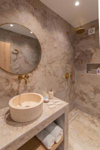 a bathroom with a sink and a large mirror at Antonis Traditional House in Afantou +44 photos