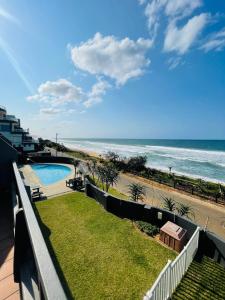 a view of the beach from the balcony of a condo at Ocean blues Isikhulu 7 in Umdloti