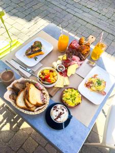 a table with a bunch of breakfast foods on it at Hotel Les Chambres de L'Opaline in Binic-Etables-sur-Mer