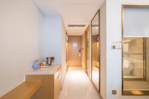 a bathroom with a sink and a toilet at Vienna Hotel Fuzhou Mawei Banzheng Cultural Scenic Area Branch in Fuzhou